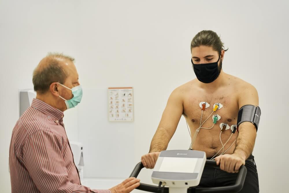 Conducting an ergometric test on a patient while riding a bicycle