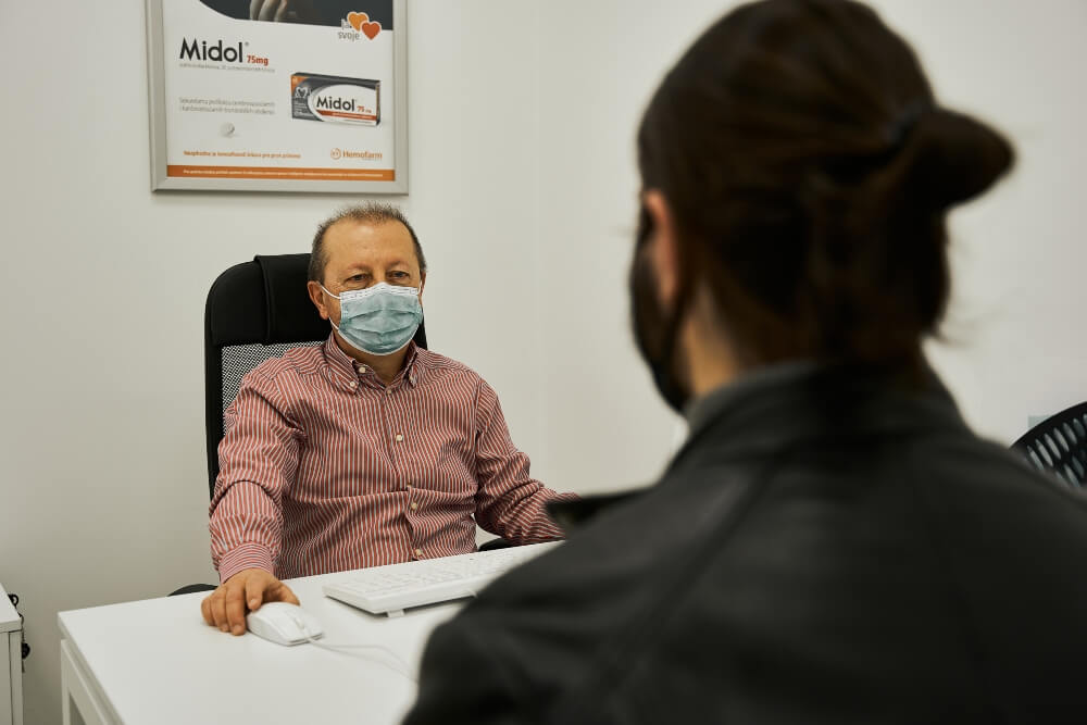 The patient talks to the doctor in the office at Pulse Cardiology Center