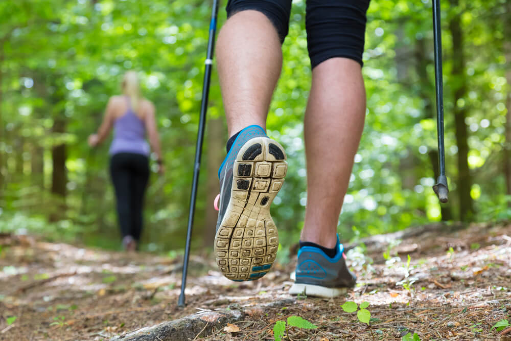 A man and a woman are walking in nature.