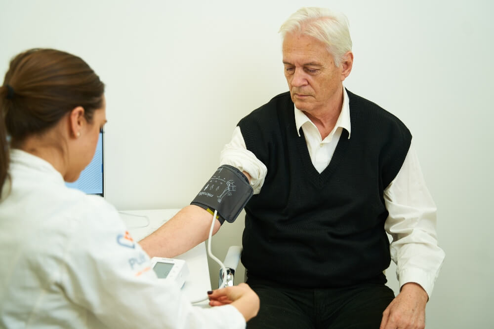 The doctor measures the patient's blood pressure during the examination at Pulse cardiology center