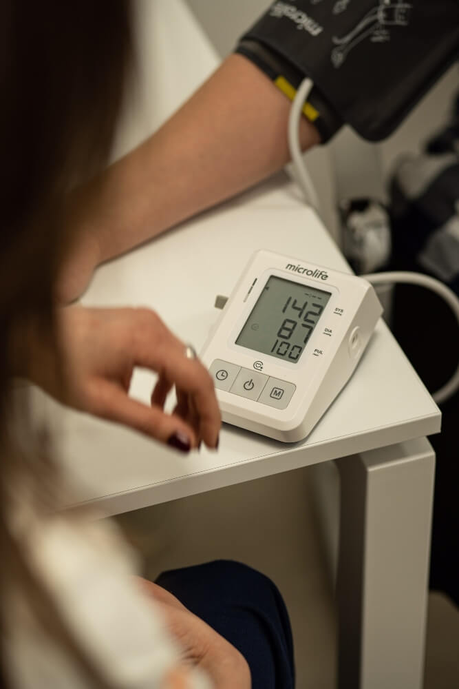 The doctor measures the patient's blood pressure at Pulse Cardiology Center