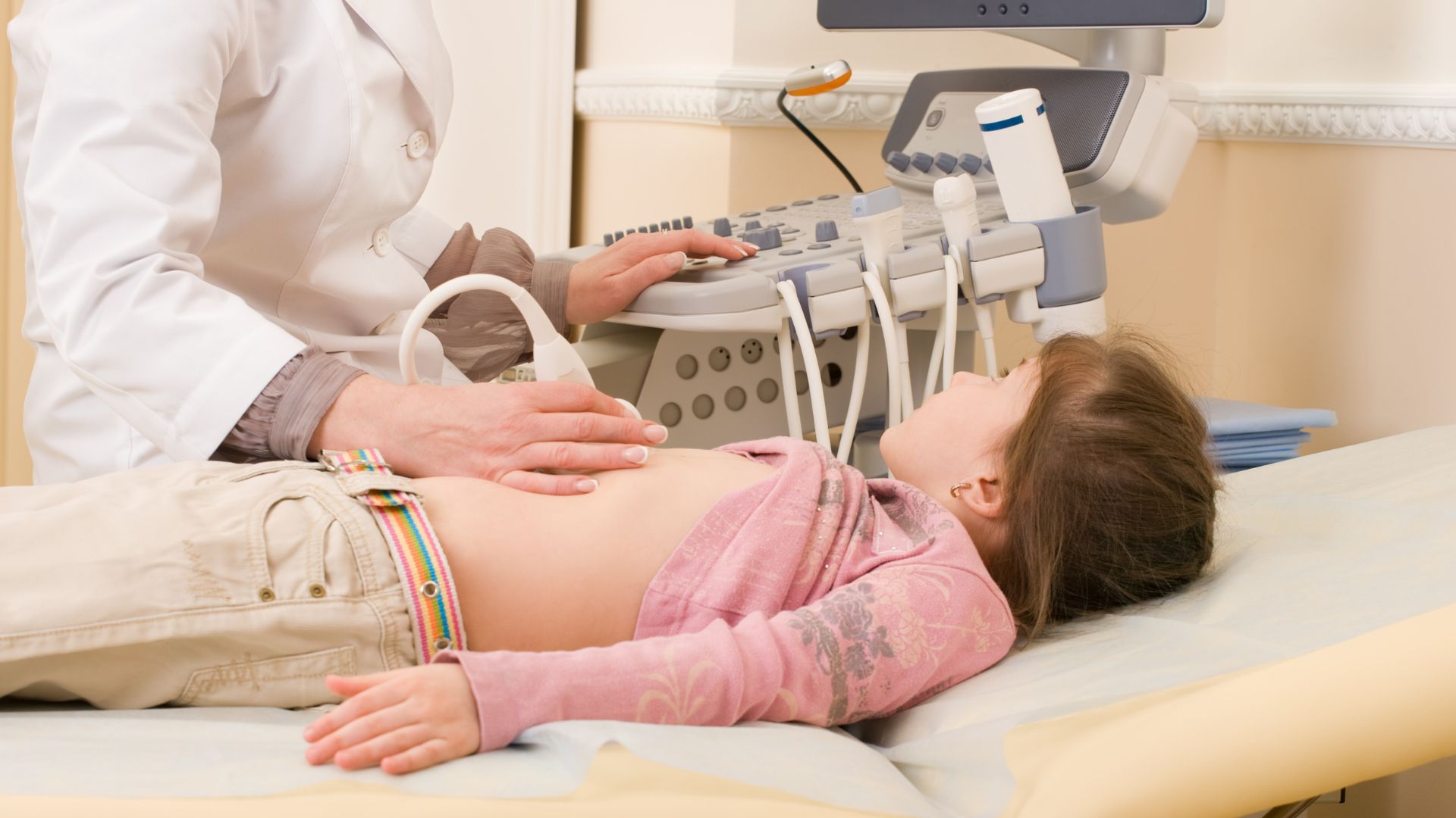 The doctor is performing an ultrasound (ECHO) of the child's heart at PULSE Cardiology Center.